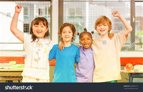 Schoolchildren Embracing Happy Multi Cultural Racial Stock Photo