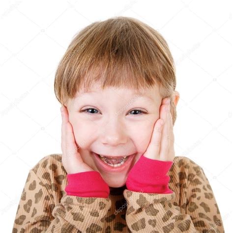 Cute Little Girl In Shirt Holding Hands To Face In Surprise Stock Photo