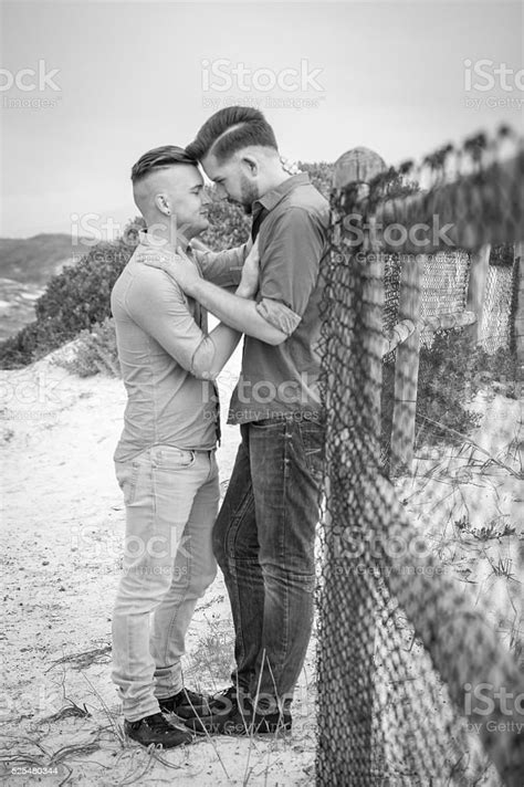 Gay Men Embracing On A Fence Stock Photo Download Image Now Adult