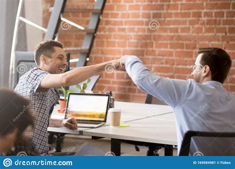 Excited Male Colleagues Give Fists Bump Greeting In Office Stock Image Image Of Agreement