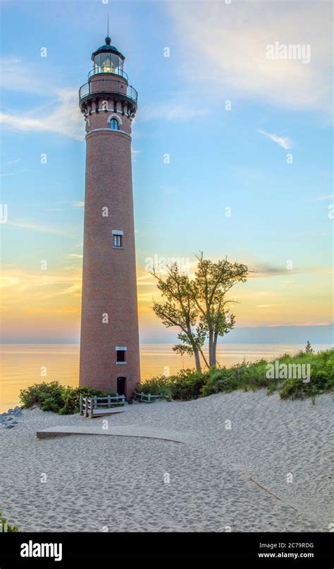 View Of Little Sable Point Lighthouse At Sunset Overlooking Lake