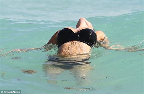 Kelly Brook Shows Off Her Assets In Black And White Bikinis As She