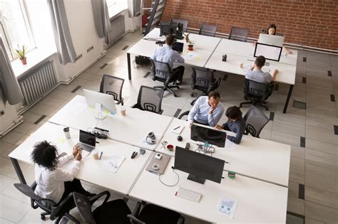 Employees Working Together In Modern Open Office Space Lmg Web