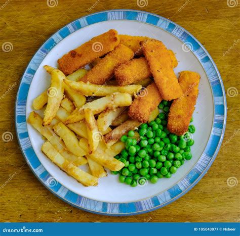 Freshly Prepared Traditional British Meal Of Fish And Chips Seen With