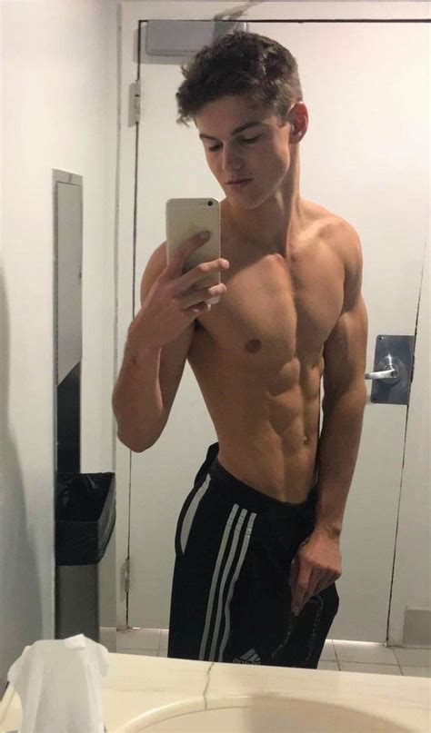 A Shirtless Man Taking A Selfie In Front Of A Mirror With His Cell Phone
