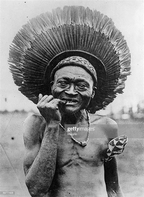 An African Man With A Traditional Feather Headdress South