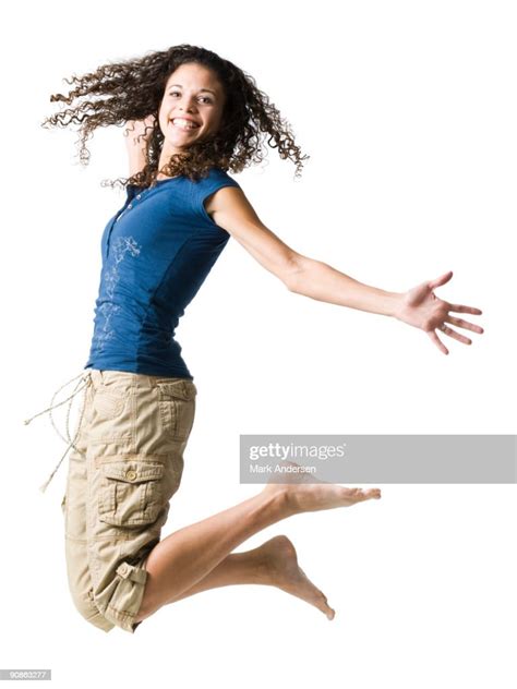 Young Woman Leaping And Smiling High Res Stock Photo Getty Images