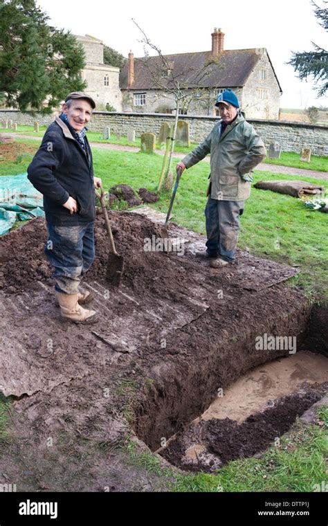 Grave Diggers Filling In A Grave At Deerhurst Gloucestershire Uk Stock