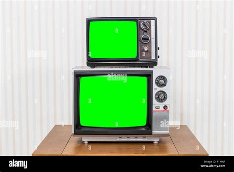 Vintage Television Stack On Old Wood Table With Chroma Key Green