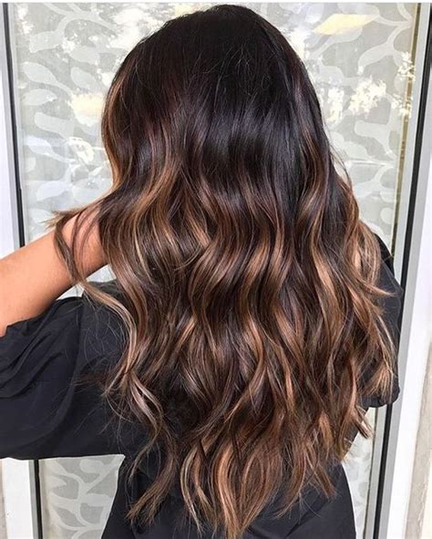 If you generally like your hair color, but want to add it some depth, dimension and trendy feel, you'll probably go for highlights, those created with a freehand technique, with no foil. Picture Of wavy black hair with caramel highlights looks ...