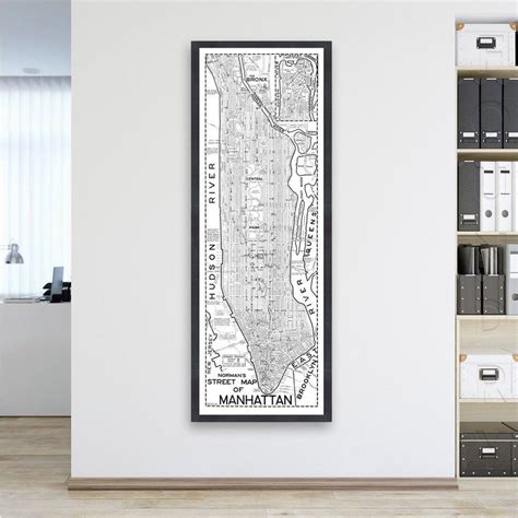 A Black And White Framed Map Hanging On The Wall In An Office With