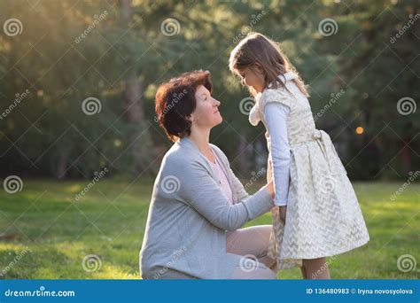 Happy Mother And Little Daughter Looking At Each Other Mother Holding