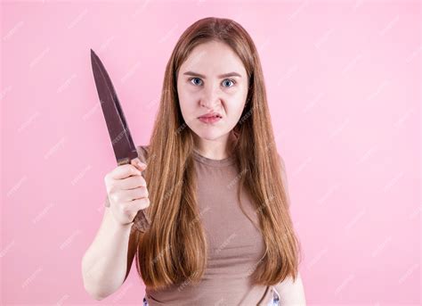 Premium Photo Angry Woman Holding A Knife In Her Hands