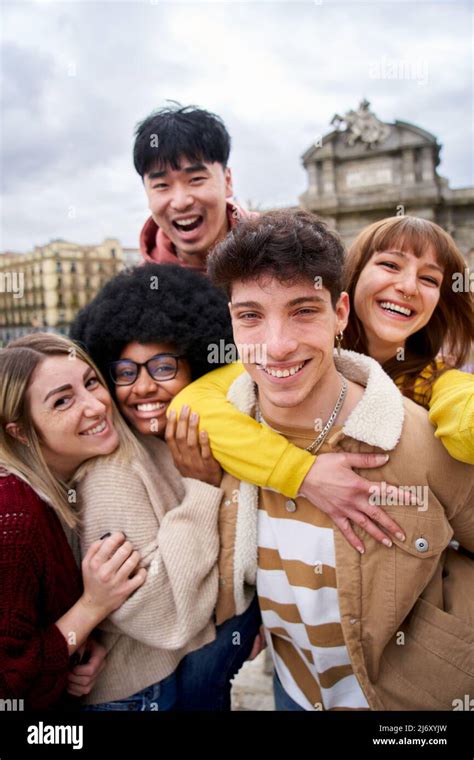Vertical Smiling Selfie Of A Group Of Happy Friends Outdoors In The