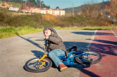 Boy Crying And Screaming After Falling Off To Bicycle Stock Photo