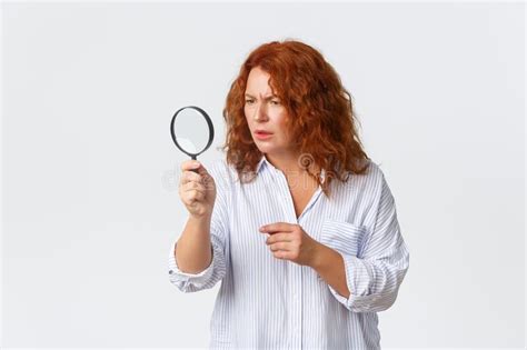 Focused Serious Looking Middle Aged Woman Searching For Something