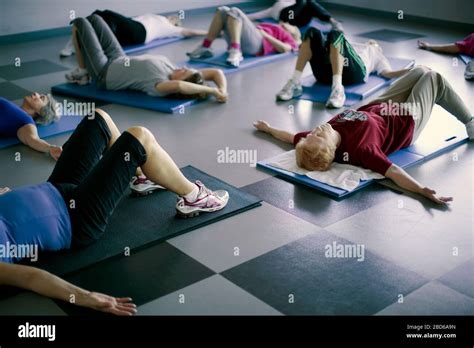 Elderly Exercise Class Stretches On Mat Stock Photo Alamy