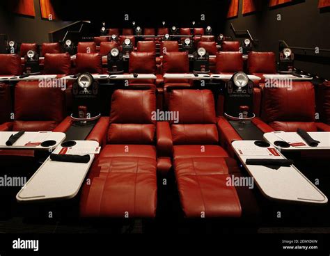 Reclining Theater Seats With Pivoting Dining Trays Are Among The