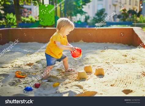 Adorable Little Girl On Playground Sandpit Stock Photo 1447587353