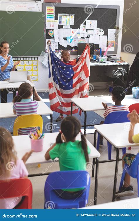 Schoolboy Holding An American Flag In Classroom Stock Image Image Of