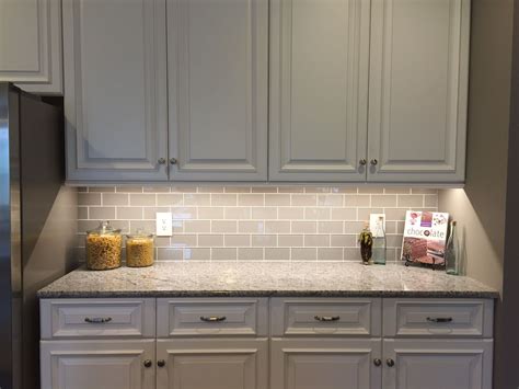 Choosing a marble backsplash for white cabinets means you are keeping the kitchen bright, but still with a bit of texture thanks to the grey coloring throughout. Smoke Glass Subway Tile | Glass subway tile backsplash, Kitchen tiles backsplash, White kitchen ...