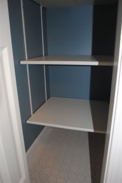 Adjustable Melamine Coated Closet Shelving In A Bathroom Linen Closet