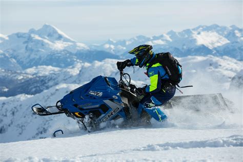 Man In Blue And Green Long Sleeved Suit Riding On Snowmobile · Free