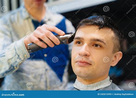 Hairdresser Makes A Haircut Of Nape For A Man With A Hair Clipper In