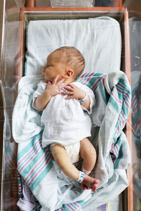 Overhead View Of Newborn Baby Boy In Hospital Bassinet Stock Photo