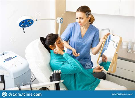 Beautician Examining Face Skin Of Female Patient Stock Photo Image Of
