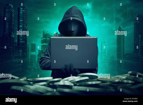 Hooded Hacker With Mask Using Laptop To Hacking Bank Stock Photo Alamy