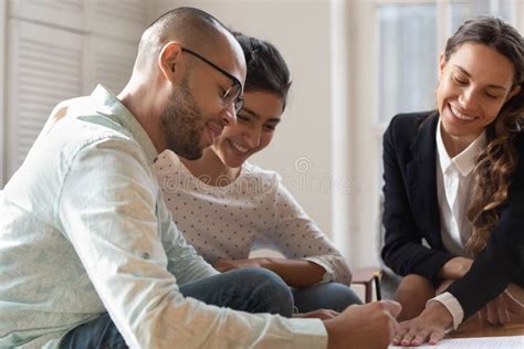 Happy Diverse Couple Signing Documents Making Successful Deal Stock