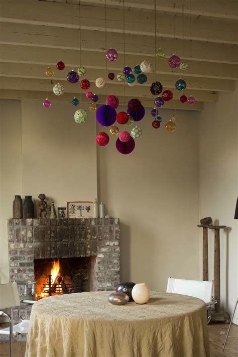 Ceiling decoration ideas diy ideas to add interest to your ceiling stained plywood slat ceiling. Sting ornaments up in a grouping over a dinner table or an ...