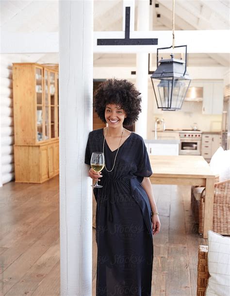 Portrait Of African American Woman In Living Room With Glass Of Wine Stocksy United American