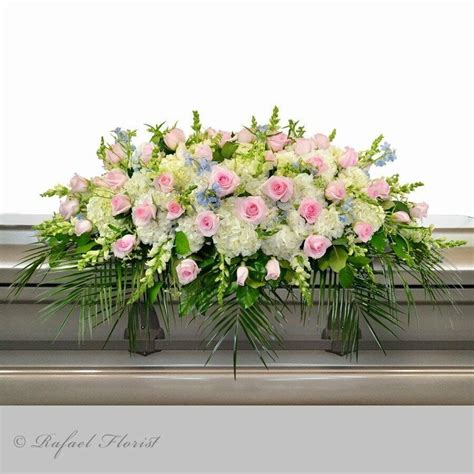 A Pastel Color Casket Spray Of Delicate Blooms In Pale Pinks And Whites