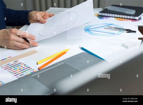 The Designer Draws Sketches Of The Brand Logo Stock Photo Alamy