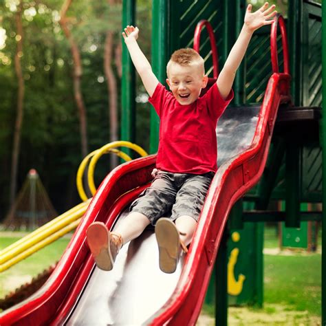 Kid Sliding Down Slide Cute Little Boy Sliding Down A Water Slide