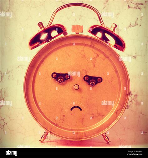 Back Of An Alarm Clock In The Shape Of A Frowning Face Stock Photo Alamy