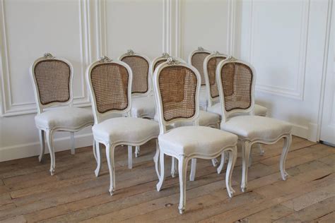 Viewed as a vintage french style, this chair is rather elegant in its design with piping detail around the chair. Set of Eight Vintage French Painted Cane Back Dining ...