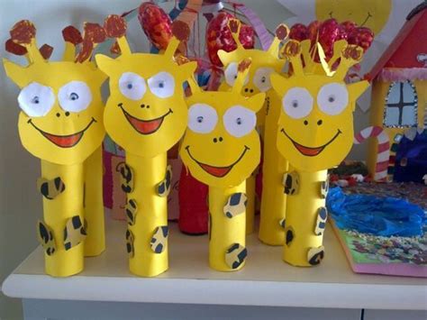Some Yellow Giraffes Are Standing Next To Each Other On A Table With