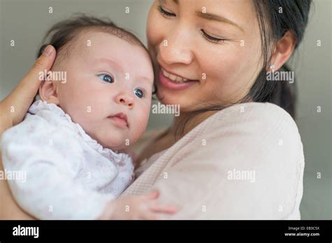 Asian Mother Holding Baby Stock Photo Alamy