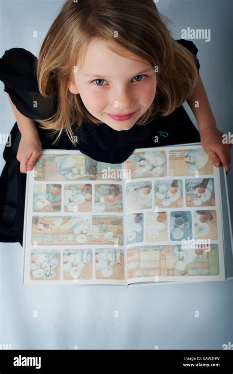 A Happy Girl Reading Colorful Book Stock Photo Alamy