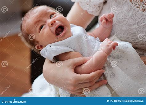 Mother Holding And Trying To Calm Her Newborn Crying Baby Stock Photo