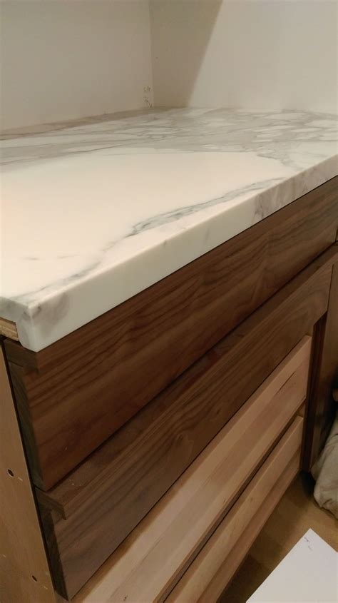 Check spelling or type a new query. Calacatta marble countertops and walnut custom cabinetry ...