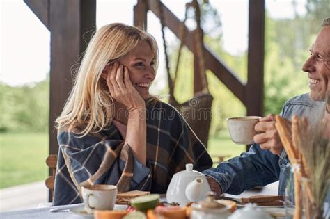 Joyful Mature Couple Enjoying Breakfast In Open Terrace Stock Image