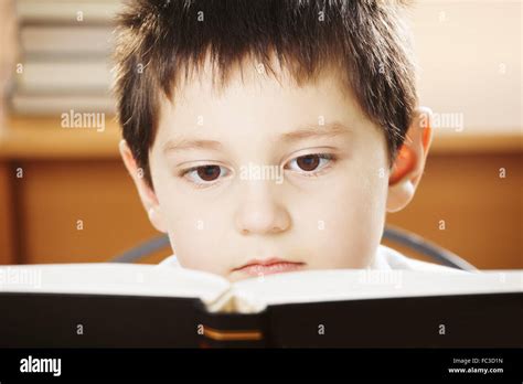 Caucasian Boy Reading Book Closeup Stock Photo Alamy