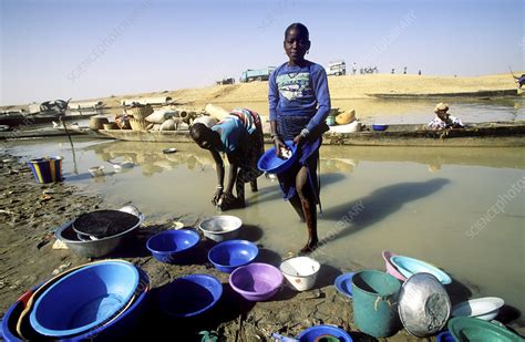 For most people, the majority of their laundry is washed with warm water. Washing in muddy river water - Stock Image - E820/0248 ...