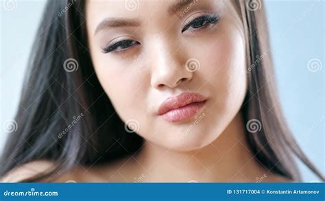 Close Up Portrait Of Charmed Asian Fashion Model With Hazel Eyes And