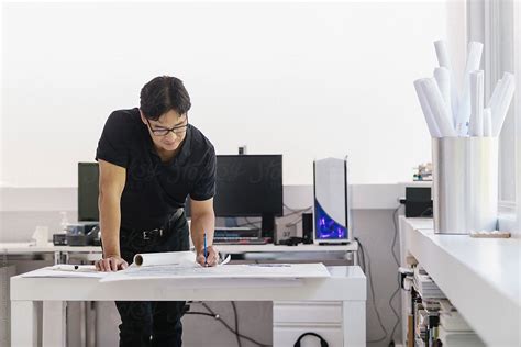 Asian Man Architect Working In Home Office By Stocksy Contributor
