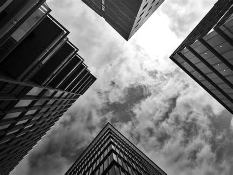 Low Angle Photography Of Gray Concrete Building Under Cloudy Sky · Free